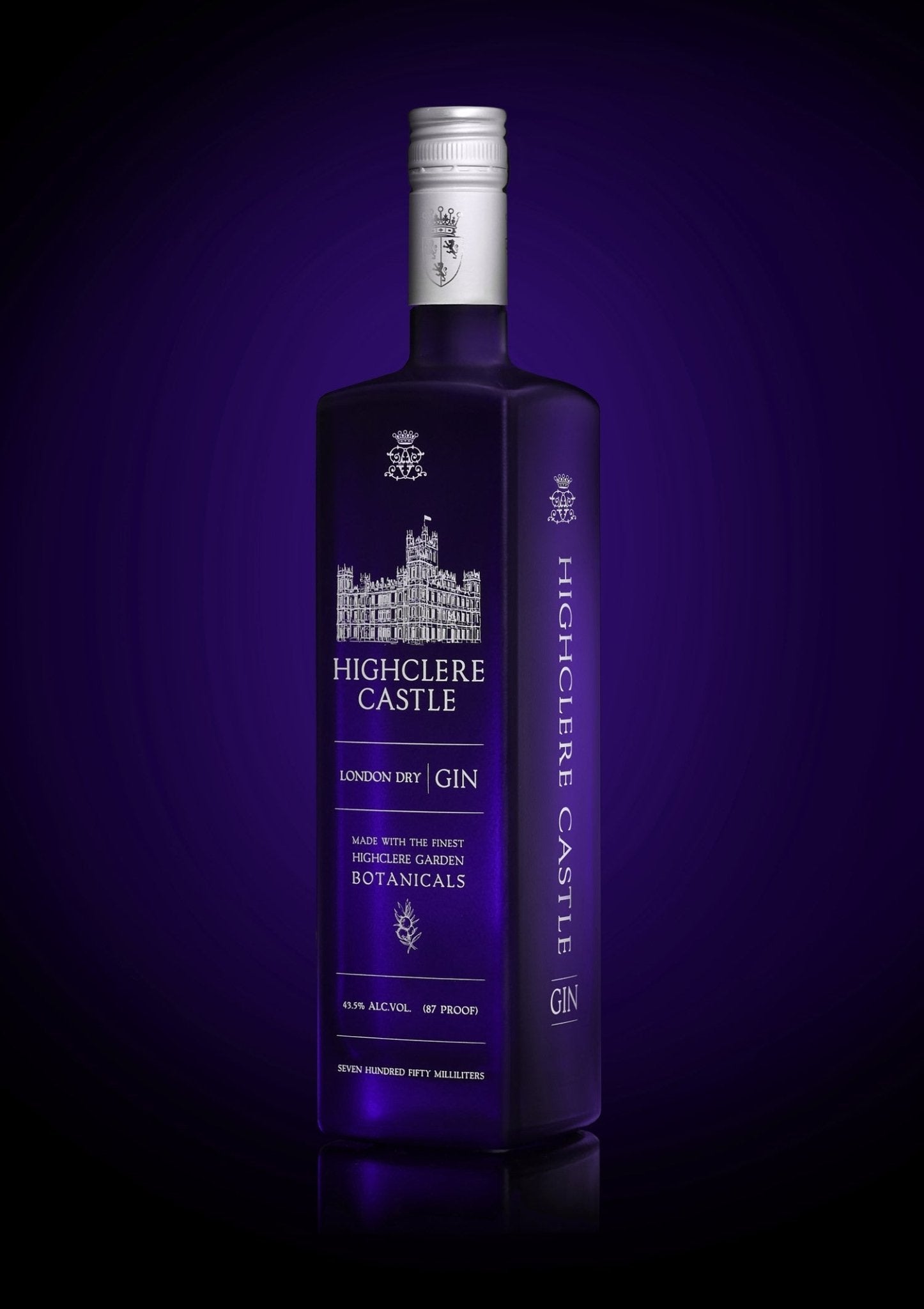 Highclere Castle Gin bottle, featuring Highclere Castle, the real Downton Abbey, with a deep purple background. London Dry Gin made with the finest botanicals from Highclere Castle gardens.