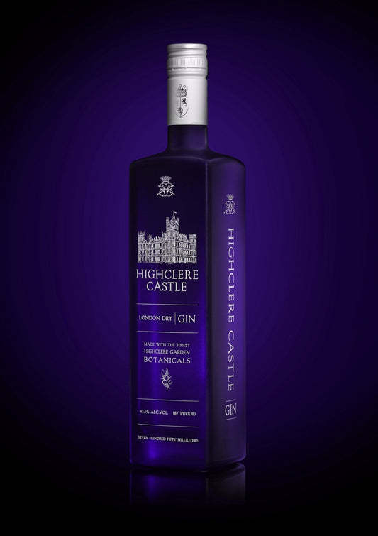 Highclere Castle Gin bottle, featuring Highclere Castle, the real Downton Abbey, with a deep purple background. London Dry Gin made with the finest botanicals from Highclere Castle gardens.